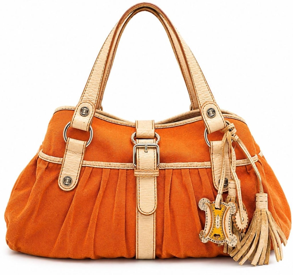 CELINE ORANGE CANVAS & LEATHER TOTE 16": This Celine tote is crafted in vibrant orange canvas with cream pebbled leather trim, dual leather shoulder straps, and polished silver-tone hardware featuring the iconic Celine Blason medallions. The