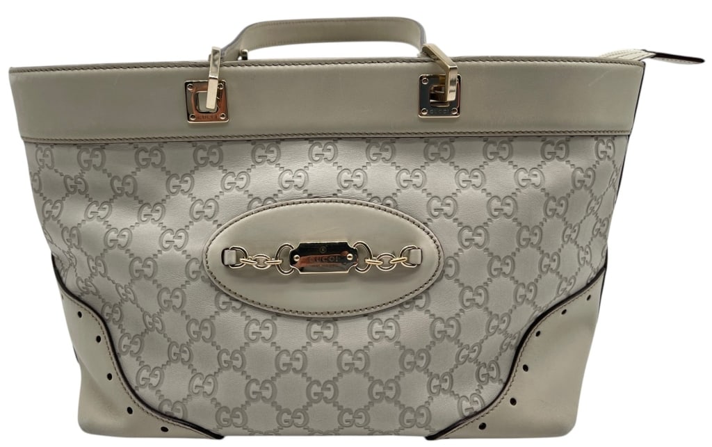 GUCCI GUCCISSIMA MEDIUM TOTE BAG 14": Gucci Guccissima medium tote crafted in white embossed leather featuring the iconic interlocking GG pattern throughout. The structured silhouette is accented with smooth leather trim, gold-tone hardwa
