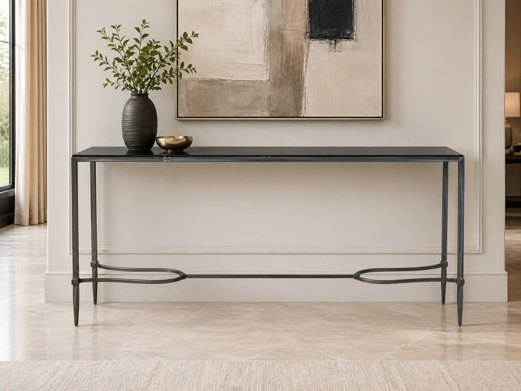 MODERN BLACK METAL CONSOLE TABLE 72": Sleek modern console table featuring a long rectangular black top supported by a slender dark metal frame with tapered legs and decorative curved lower stretcher detail. The clean linear form gives th