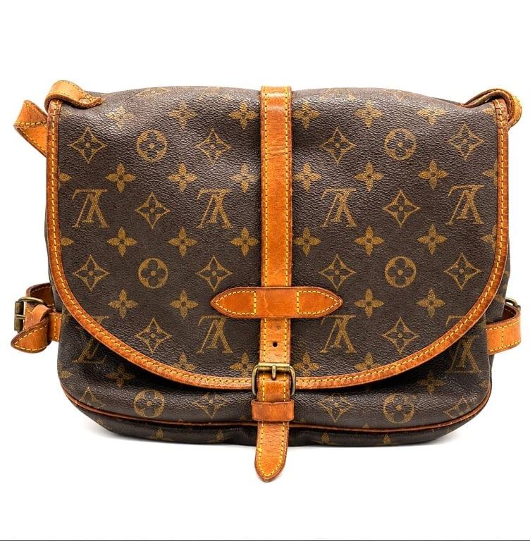 LOUIS VUITTON MONOGRAM SAUMUR BAG 12": Authentic vintage Louis Vuitton Saumur shoulder/crossbody bag crafted in signature Monogram coated canvas with natural Vachetta leather trim and brass-tone hardware. Classic saddle-inspired design