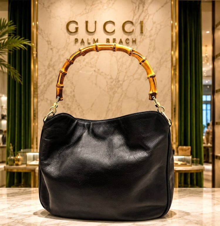 GUCCI BAMBOO BLACK LEATHER HANDBAG 14": vintage Gucci Bamboo handbag crafted in supple black leather with the iconic curved natural bamboo top handle and gold-tone hardware. This classic Gucci hobo-style handbag features a softly