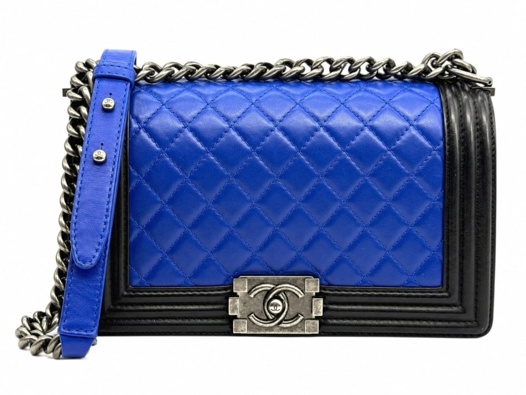 CHANEL BOY BAG FLAP BAG ROYAL BLUE & BLACK 10": This striking Chanel Boy Flap Bag features luxurious royal blue quilted leather contrasted with black leather trim and Chanel's coveted aged gunmetal hardware. One of the house's most recognizable con