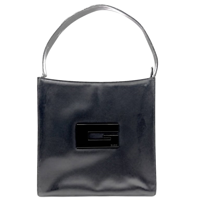 VINTAGE GUCCI BLACK LEATHER SHOULDER BAG 18": Vintage Gucci shoulder bag crafted in smooth black leather with a sleek rectangular silhouette and single shoulder strap. Front features a distinctive raised black geometric GG plaque marked "GUCCI," 
