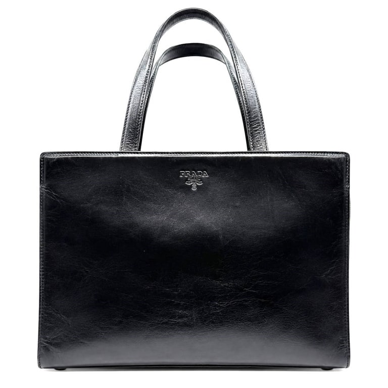 PRADA MILANO BLACK LEATHER TOTE BAG 13": Vintage Prada Milano structured tote handbag crafted in glossy black leather with a clean rectangular silhouette and dual leather top handles. The front is embossed with the PRADA MILANO DAL 1913 cres