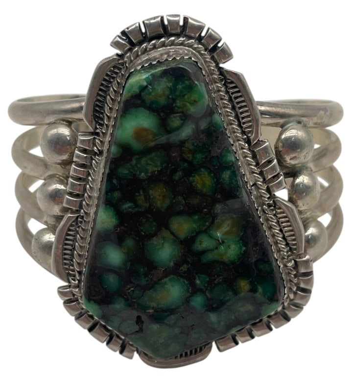 NAVAJO STERLING AND TURQUOISE CUFF BRACELET 80G: Sterling silver cuff bracelet featuring a substantial freeform turquoise cabochon displaying a striking spiderweb matrix in shades of deep green, blue-green, and black. The handcrafted cuff showcases 