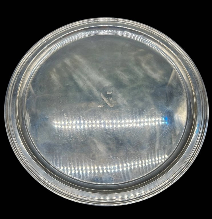 TIFFANY & CO STERLING SILVER TRAY 648 GRAMS 12": Tiffany & Co. sterling silver round serving tray featuring a classic stepped and molded border with elegant engraved script monogram at center. Reverse is clearly stamped ?TIFFANY & CO. / MAKERS / STE