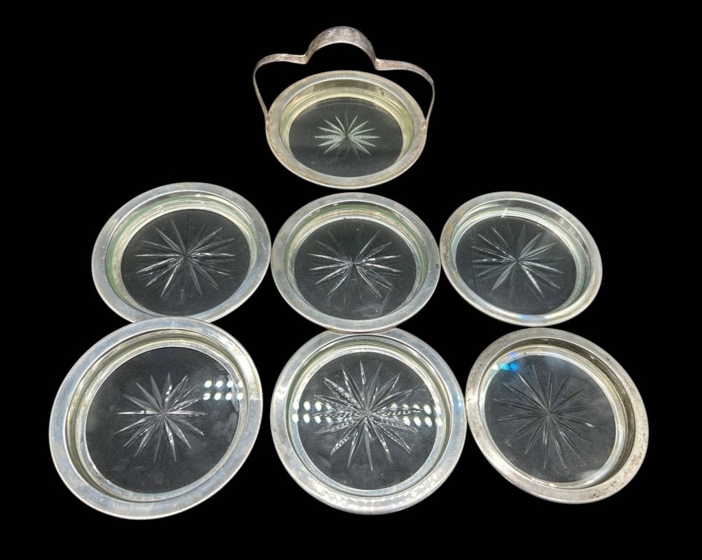 STERLING SILVER CUT GLASS COASTERS SET OF 6 456G: Elegant vintage set of six sterling silver and cut glass coasters with a matching handled holder/caddy. Each coaster features a clear glass insert with deeply cut radiating starburst design surrounded