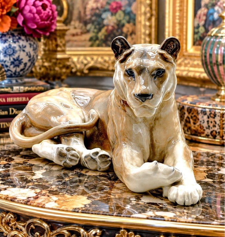 ROYAL COPENHAGEN PORCELAIN LIONESS 12": Impressive vintage Royal Copenhagen porcelain lioness figurine, beautifully modeled in a relaxed reclining pose with crossed forepaws, curled tail and an alert, expressive face. Finished in Royal