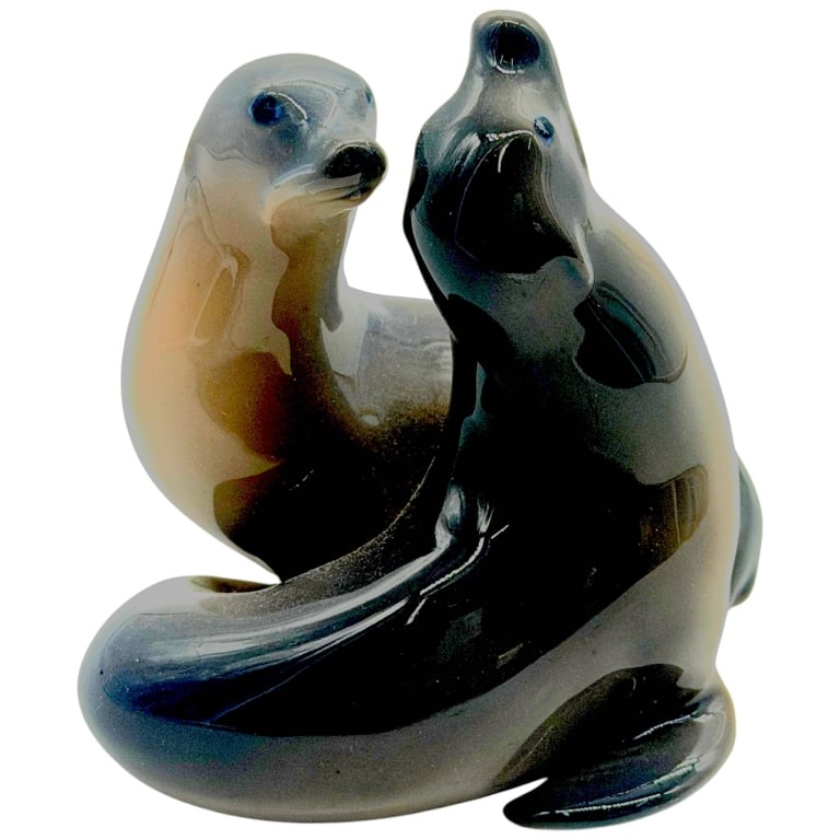 ROYAL COPENHAGEN PORCELAIN SEA LIONS 4": Royal Copenhagen Danish porcelain figurine depicting a charming pair of sea lions/seals posed together in a fluid sculptural composition. Beautifully glazed in graduated charcoal gray, black, taupe an