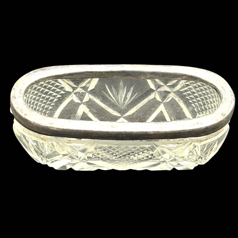 CUT CRYSTAL & SILVER MOUNTED DISH 2.5": Elegant vintage oval cut crystal dish featuring deeply cut geometric decoration with crosshatched diamond panels, faceted star and fan motifs, and a substantial clear crystal body. The upper edge is f