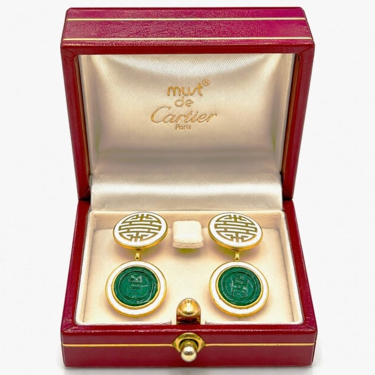 CARTIER 18K & JADE ASIAN MOTIF CUFFLINKS W/ BOX: Vintage Cartier Paris double-sided cufflinks featuring an elegant Asian-inspired design in 18K yellow gold with white enamel accents and deep green carved jade medallions. Each cufflink combines a cir