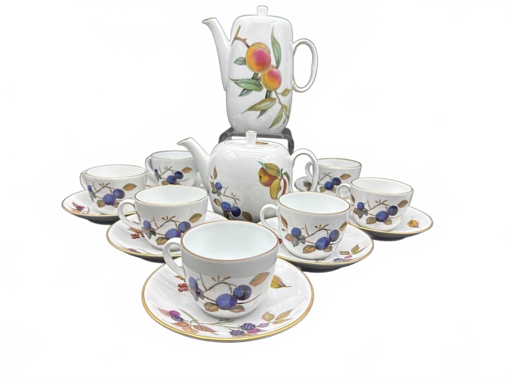 Royal Worcester Evesham Tea and Coffee Set: This fine porcelain set from Royal Worcester's Evesham collection includes a teapot, coffee pot, and six matching teacup and saucer pairs. Each piece is decorated with colorful fruit motifs and gold