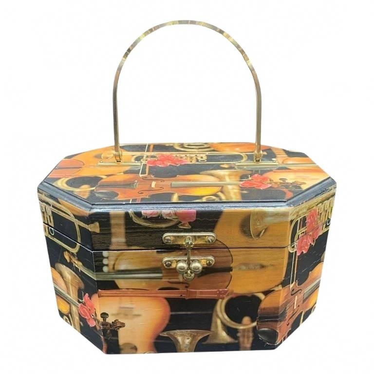 VINTAGE OCTAGONAL MUSICAL THEME WOODEN BOX 8": Octagonal wooden jewelry box featuring musical instrument imagery, gold-tone handle, red velvet-lined interior. Bottom inscribed and dated 1979. Unique decorative collectible with secure clasp, ideal 