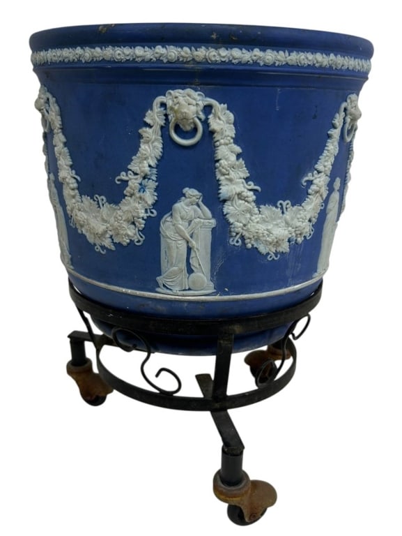 ANTIQUE WEDGWOOD JASPERWARE JARDINIERE 14": Large antique English cobalt-blue jasperware jardiniere or cachepot, decorated in high-relief white classical ornament in the manner of Wedgwood. The substantial cylindrical vessel features applied fl