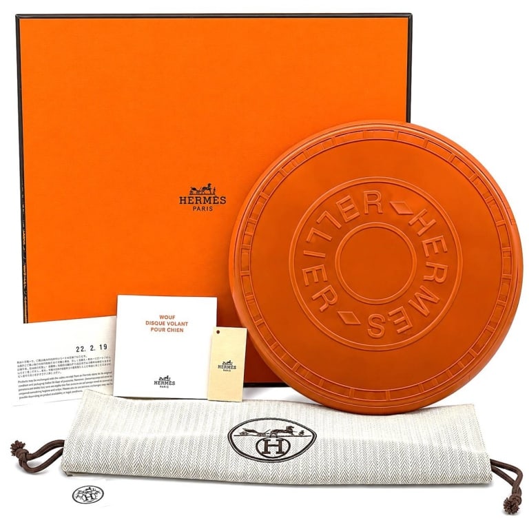 HERMES WOUF DOG FRISBEE NWT & COLLECTOR BOX 8": Hermes Paris Wouf Disque Volant Pour Chien luxury dog flying disc, an exceptional designer pet accessory presented in signature Hermes orange. The circular molded disc features raised HERMES SELLIER l