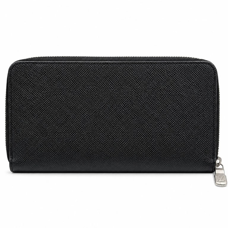 LOUIS VUITTON BLACK TAIGA ZIPPY WALLET 8": Louis Vuitton Zippy-style long wallet crafted in black textured Taiga leather with silver-tone hardware and LV-engraved zipper pull. Zip-around design opens to a black leather interior with multiple c