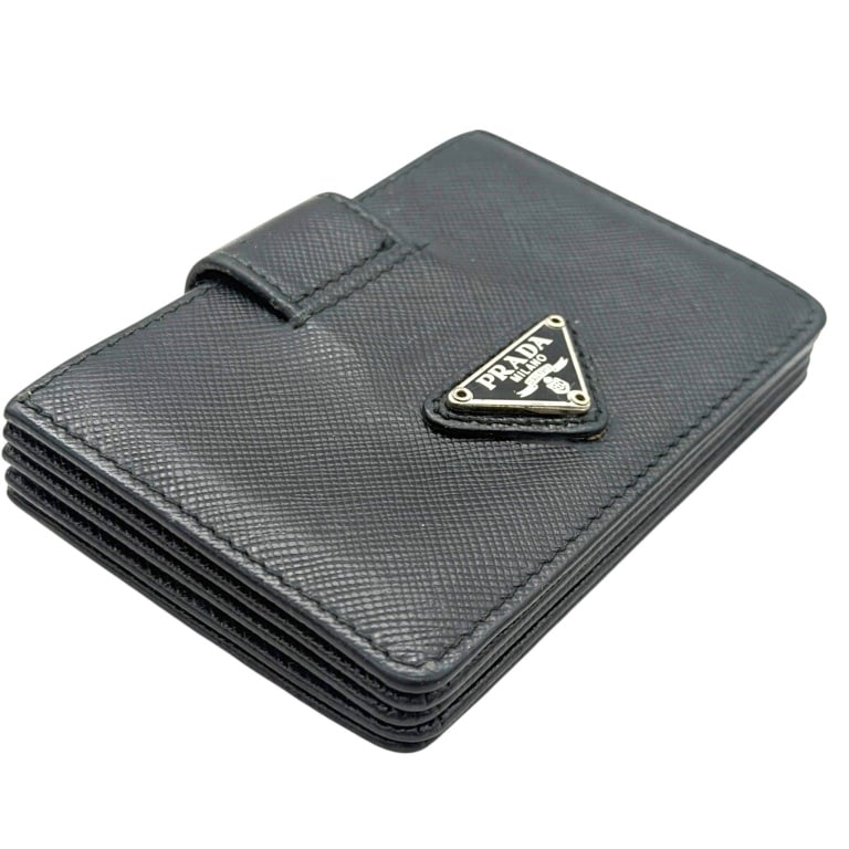 PRADA SAFFIANO LEATHER CARD HOLDER 4": Prada Milano black Saffiano leather accordion card holder, crafted in the Italian luxury house's signature crosshatched leather. Compact structured design features the iconic enamel and silver-tone tr