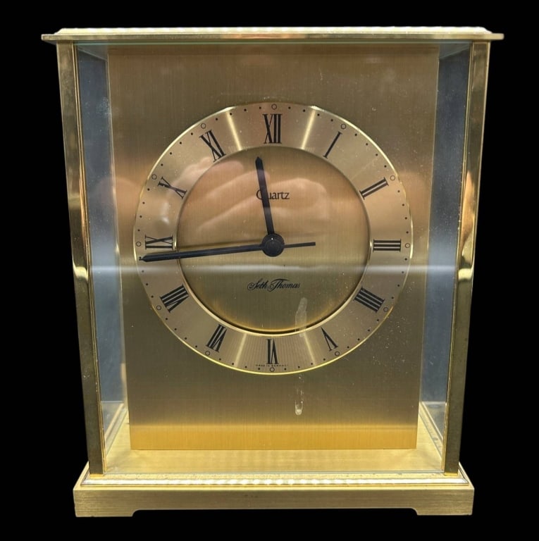SETH THOMAS GERMAN QUARTZ BRASS CLOCK 9": Vintage Seth Thomas quartz mantel or desk clock featuring a handsome architectural brass-tone case with glass side panels and a brushed gold-tone dial. The circular dial displays black Roman numerals,