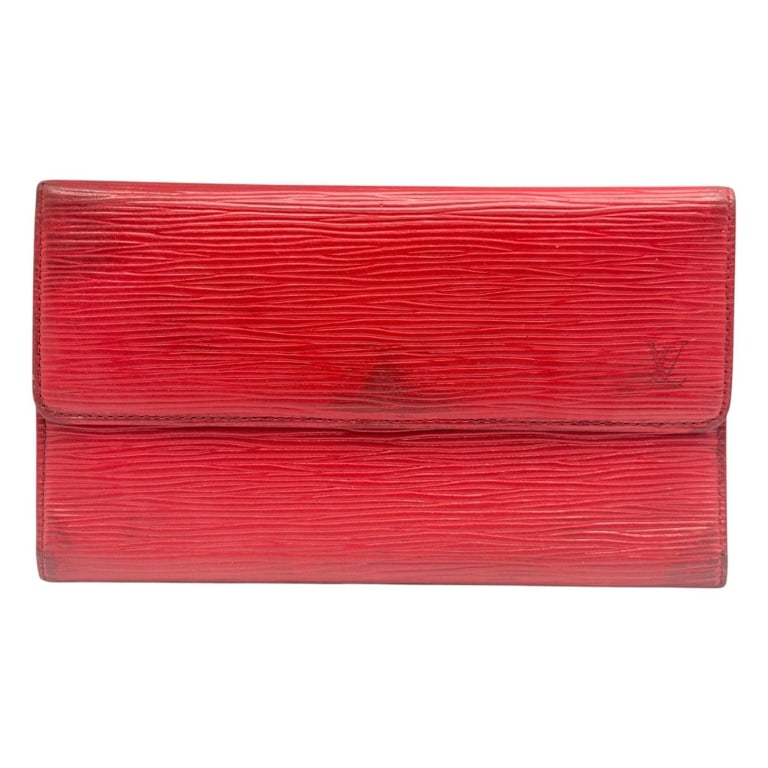LOUIS VUITTON RED EPI LEATHER WALLET 7.5": Vintage Louis Vuitton long continental wallet crafted in vibrant red Epi leather with the house?s distinctive textured wave grain and subtle embossed LV monogram at the lower corner. Features a snap-f