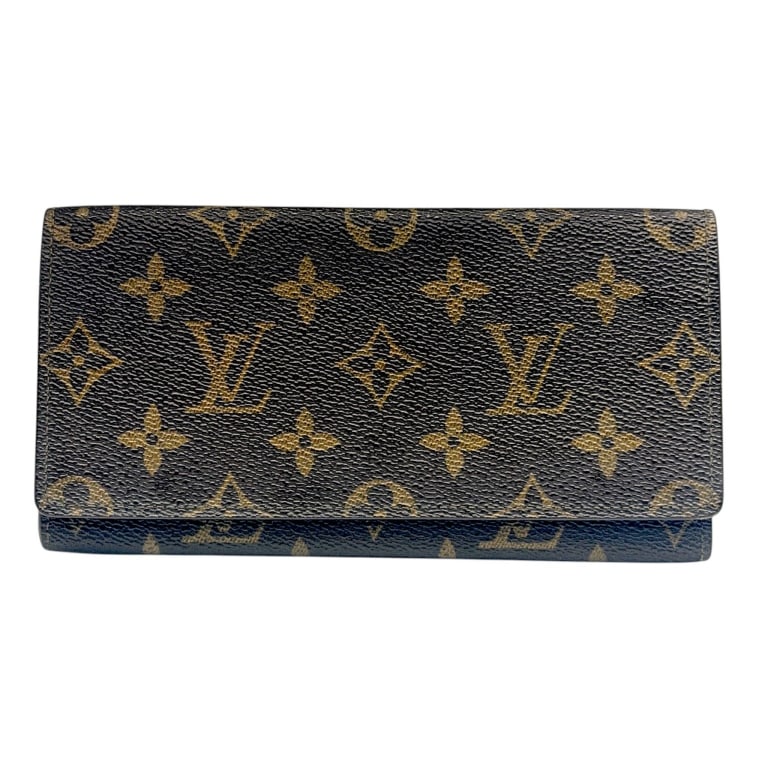 LOUIS VUITTON MONOGRAM SARAH WALLET 7.5": Vintage Louis Vuitton Sarah long wallet crafted in classic brown Monogram coated canvas with LV initials and floral motifs throughout. Traditional envelope-style flap opens to a brown cross-grain leat