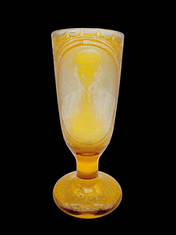 ETCHED AMBER GLASS ROMENESKY PORTRAIT GOBLET 8": Distinctive vintage amber glass pedestal goblet featuring an intricately etched portrait of a bearded gentleman within an oval reserve. The portrait is surrounded by finely engraved neoclassical-style