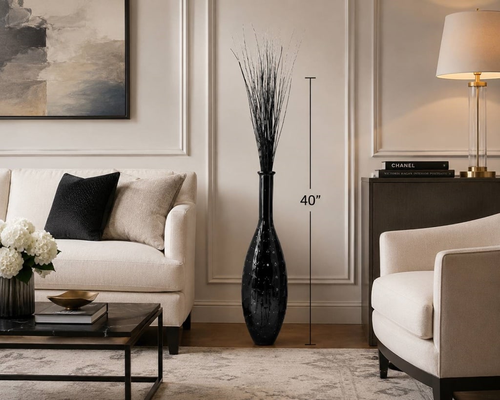 TALL SMOKED GLASS FLOOR VASE WITH REEDS 40": Tall smoked-gray glass floor vase featuring an elongated bottle form with a rounded body, narrow neck, and flared rim. The glass is decorated with an allover raised circular pattern that creates textu