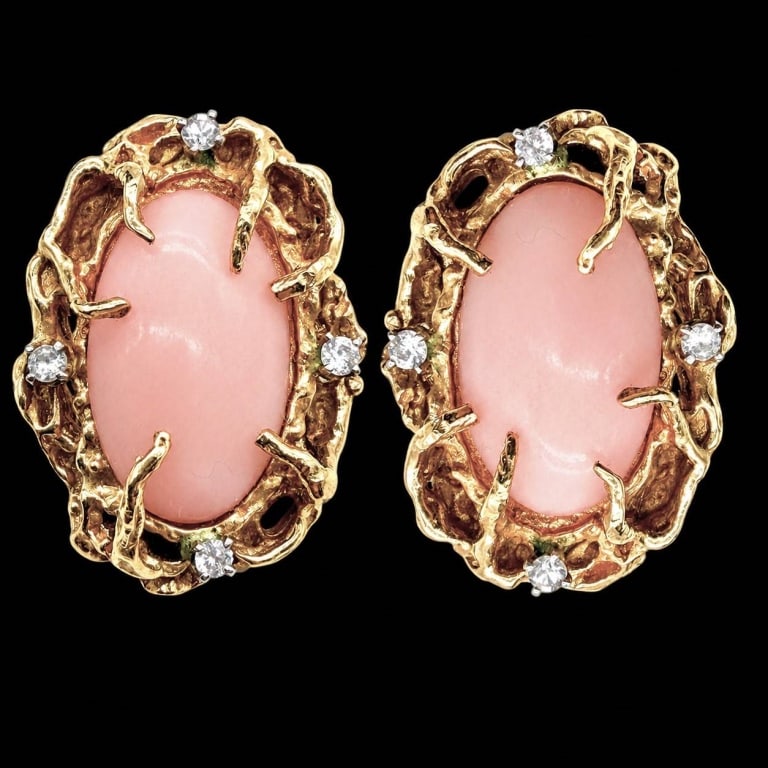 14K GOLD ANGEL SKIN & DIAMOND CLIP EARRINGS: Elegant vintage 14K yellow gold clip earrings, each centered by a large oval angel skin coral cabochon displaying the variety?s desirable soft blush-pink coloration. The substantial organic openwork g