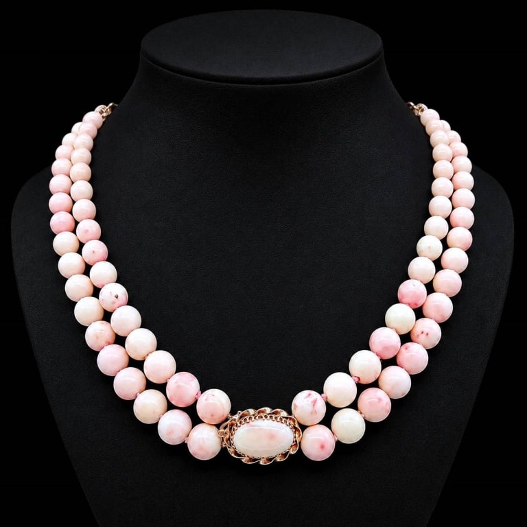 14K GOLD ANGEL SKIN CORAL NECKLACE: Elegant vintage double-strand necklace composed of graduated round angel skin coral beads displaying soft blush-pink, ivory and naturally mottled coloration. The strands are completed by an ornate 14K