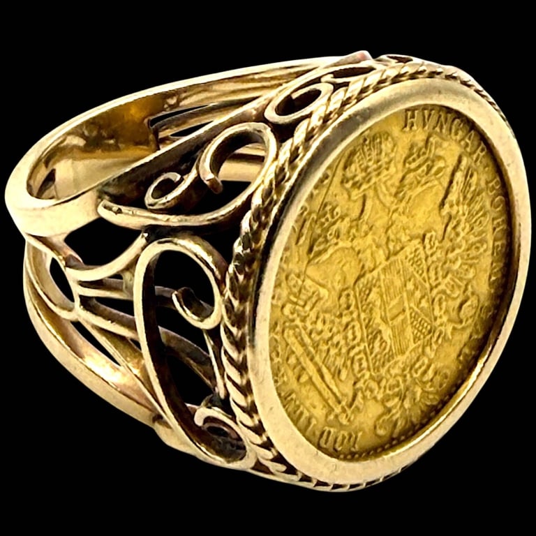 14K GOLD ANTIQUE COIN FILIGREE RING: 14K GOLD ANTIQUE COIN FILIGREE RING SZ 7 11.8G | | Distinctive 14K yellow gold ring centering an antique coin within a substantial rope-twist bezel. The wide shoulders feature elaborate openwork filig