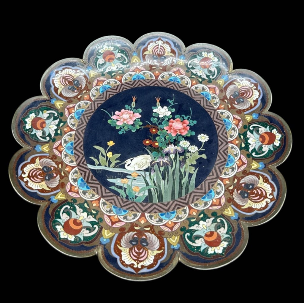 CHINESE CLOISONNE FLORAL CRANE CHARGER 14.5": Large Chinese cloisonne enamel charger featuring an elaborate scalloped floral-form border surrounding a central garden scene. The deep cobalt-blue center depicts a white crane or heron among flowerin