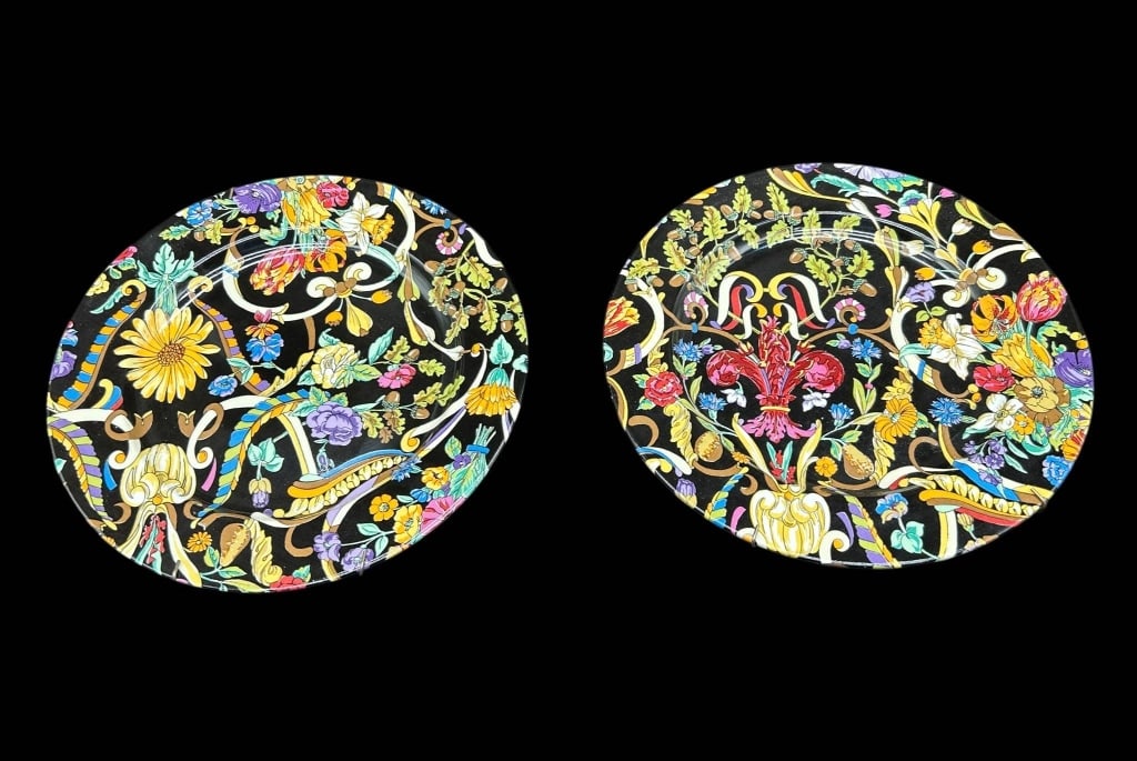 GUCCI FLORAL PORCELAIN PLATES PAIR 8": Pair of authentic Gucci decorative porcelain plates, each featuring an exceptionally vibrant multicolor floral and botanical design against a dramatic black ground. The elaborate composition incorpora