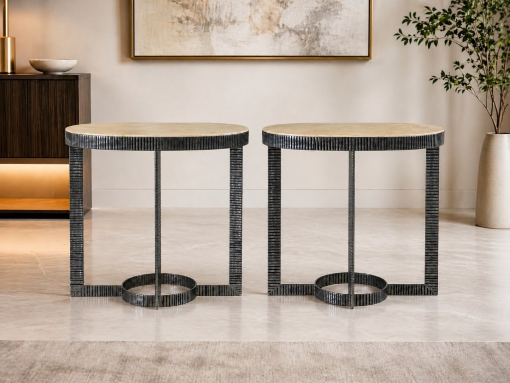PAIR OF MODERN OVAL ACCENT TABLES 28": Pair of contemporary oval accent tables featuring light champagne-tone stone-look tops with dark ribbed metal architectural bases. Each table has an open geometric frame with four legs, textured verti