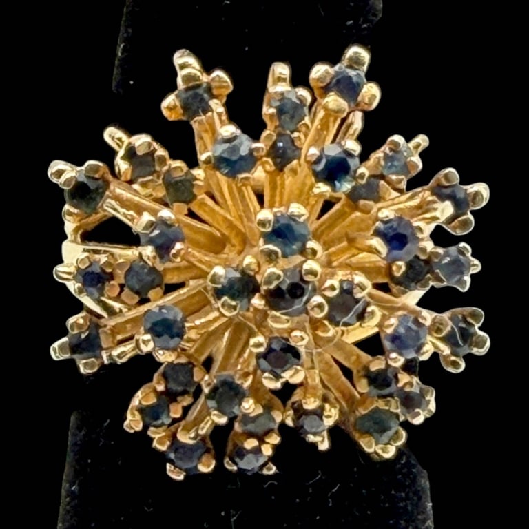 14K GOLD BLUE SAPPHIRE STARBURST RING: 14K GOLD SAPPHIRE STARBURST RING 11.2G SZ 7.25 | | Dramatic 14K yellow gold cocktail ring designed as a dimensional starburst or floral spray. Numerous round-cut blue sapphires are individually set am