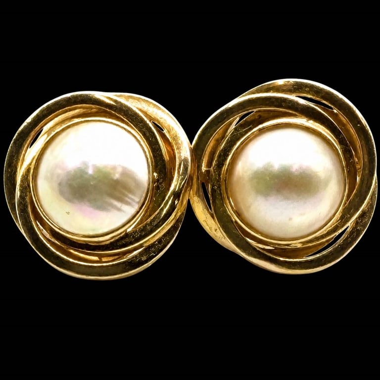 14K GOLD PEARL SWIRL STUD EARRINGS: 14K GOLD PEARL SWIRL STUD EARRINGS | | Elegant 14K yellow gold stud earrings, each centered by a luminous cultured pearl with creamy white coloration, soft iridescent overtones and natural surface