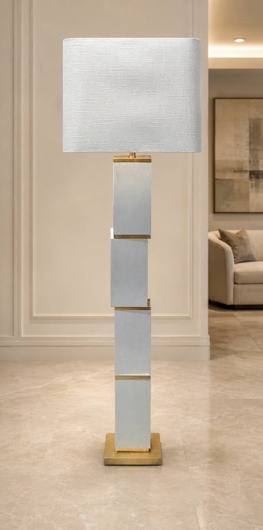 MODERN GEOMETRIC GILT ACCENT FLOOR LAMP 63": Modern floor lamp featuring a sculptural column composed of graduated rectangular blocks in a softly textured silver-white finish, separated by slender gilt-metal accent bands. The architectural body 