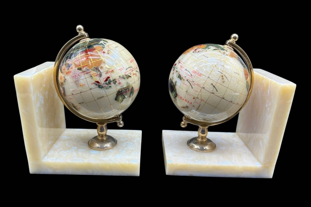 PAIR GEMSTONE WORLD GLOBE BOOKENDS 7": Pair of decorative world globe bookends featuring polished cream-toned stone or shell-style globes with colorful inset continents and iridescent abalone-style accents. Each globe is mounted within a g