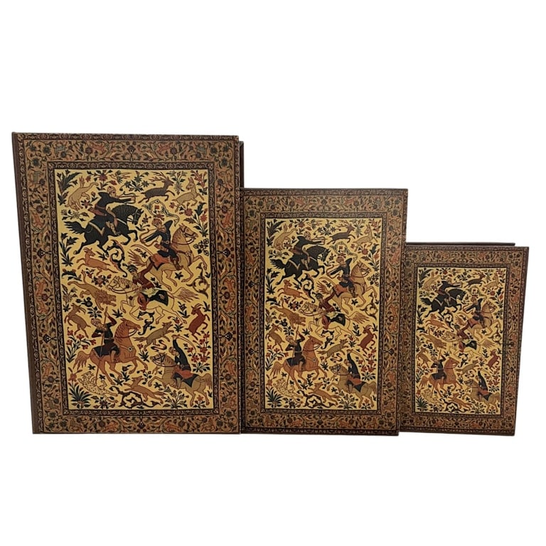 DECORATIVE FAUX BOOK STORAGE BOXES SET OF 3 16": Set of three graduated decorative faux book storage boxes designed to resemble richly bound antique volumes. Each features a brown leather-look exterior with ornate gilt floral and foliate decoration 
