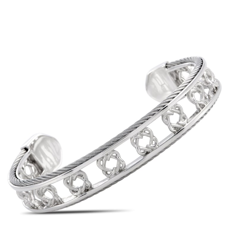 CHARRIOL HEART TO HEART STERLING SILVER BANGLE BRA: The Charriol Heart to Heart bracelet is crafted from sterling silver and weighs 25.2 grams, measuring 7.85 in length and 2.50 in diameter.This jewelry piece is offered in brand new condition and inclu
