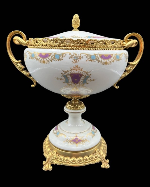 ORMOLU MOUNTED PORCELAIN COVERED URN 11": Elegant Continental-style porcelain and gilt bronze or brass mounted covered urn featuring a white glazed porcelain body richly decorated with neoclassical motifs in lavender purple, turquoise blue an