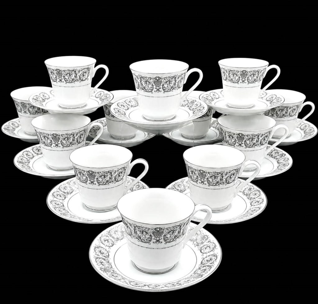 ELEGANTE BY TOWNE HOUSE CUPS & SAUCERS 22PC: Elegant 22-piece Towne House Fine China tea cup and saucer set, made in Japan in the ELEGANTE pattern No. 3100. The service features bright white fine china with an ornate gray scrolling floral and fo