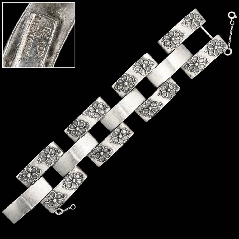 MEXICO ALPACA SILVER FLORAL LINK BRACELET 8": Vintage Mexican alpaca silver link bracelet featuring a bold geometric construction of broad rectangular articulated links decorated with raised stylized floral motifs and scrolling accents. The