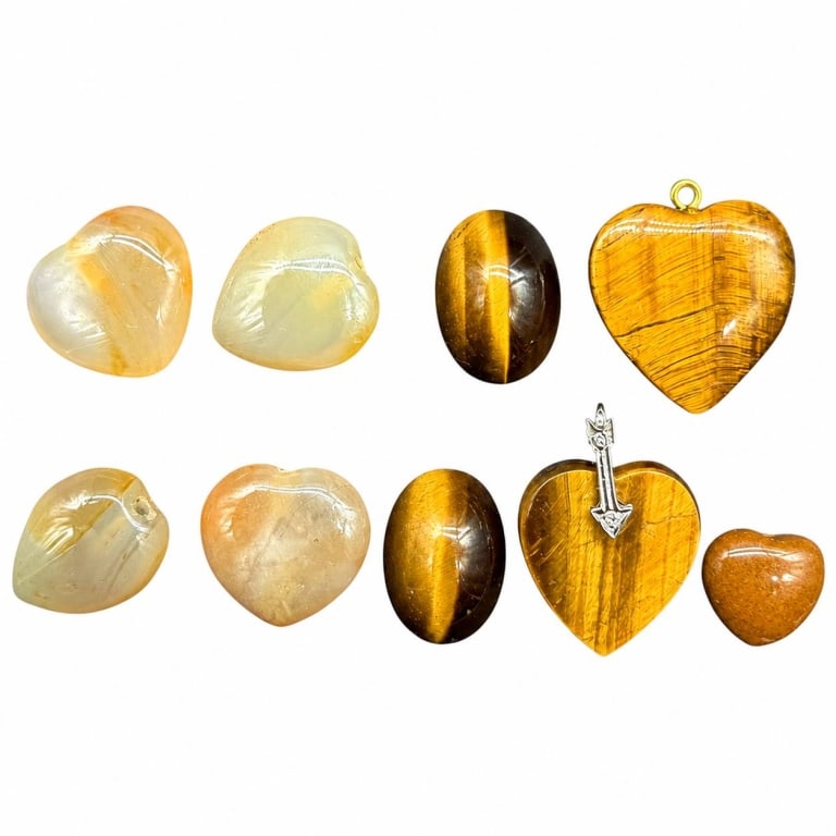 TIGERS EYE POLISHED STONE HEART LOT 1": Decorative collection of 9 polished gemstone and mineral pieces featuring rich golden tiger's eye and pale translucent stones. The group includes two oval tiger's eye cabochons displaying strong golde