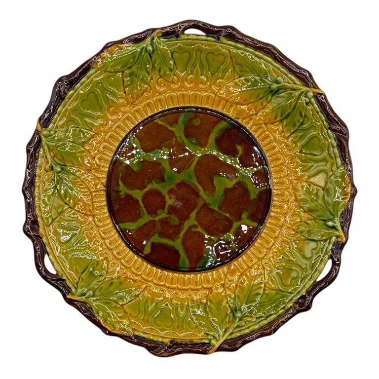 MAJOLICA GRAPE VINE SERVING BOWL 9": Colorful majolica-style ceramic serving bowl featuring richly molded grapevine and foliate decoration in vibrant shades of olive green, golden yellow and deep brown. The center is decorated with clust