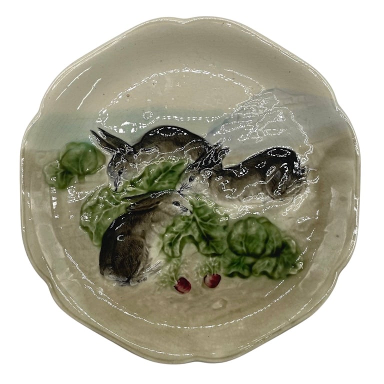 MAJOLICA RABBIT VEGETABLE SERVING BOWL 9": Decorative majolica-style ceramic serving bowl featuring a charming raised rabbit motif surrounded by richly modeled leafy vegetables and small red accents. The naturalistic rabbit is rendered in shad