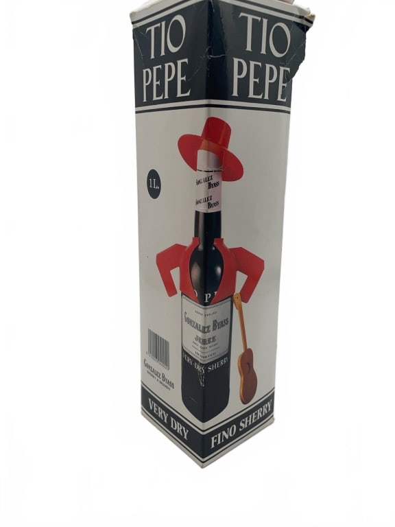 Tio Pepe Fino Sherry 1L Box Pack: Tio Pepe Fino Sherry, 1 liter bottle, presented in original Gonzales Byass branded box. Packaging features a red-hat character motif and denotes 'Very Dry' style. Some wear is visible on the box.