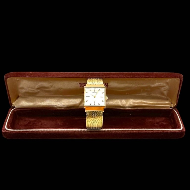 VINTAGE BERCONA 18K GOLD WATCH 25MM: Elegant vintage Bercona wristwatch crafted in 18K yellow gold, featuring a square case and a silver-tone dial with applied baton hour markers and gold-tone hands. The dial is signed ?Bercona? and ?Inc