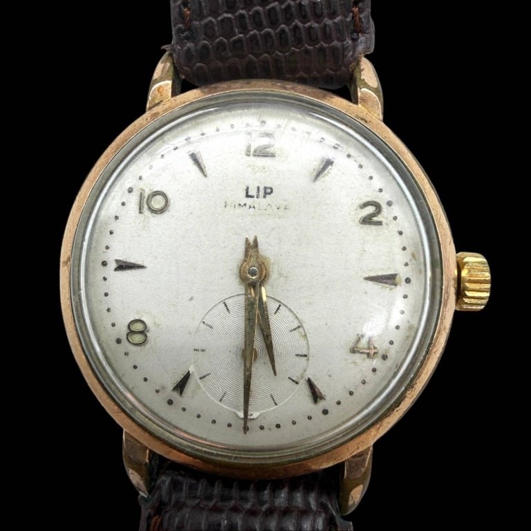 VINTAGE LIP HIMALAYA MECHANICAL WATCH 34MM: VINTAGE BERCONA 18K GOLD WATCH 25MM | | VINTAGE BERCONA 18K GOLD WATCH 25MM | | Elegant vintage Bercona wristwatch crafted in 18K yellow gold, featuring a square case and a silver-tone dial with appli