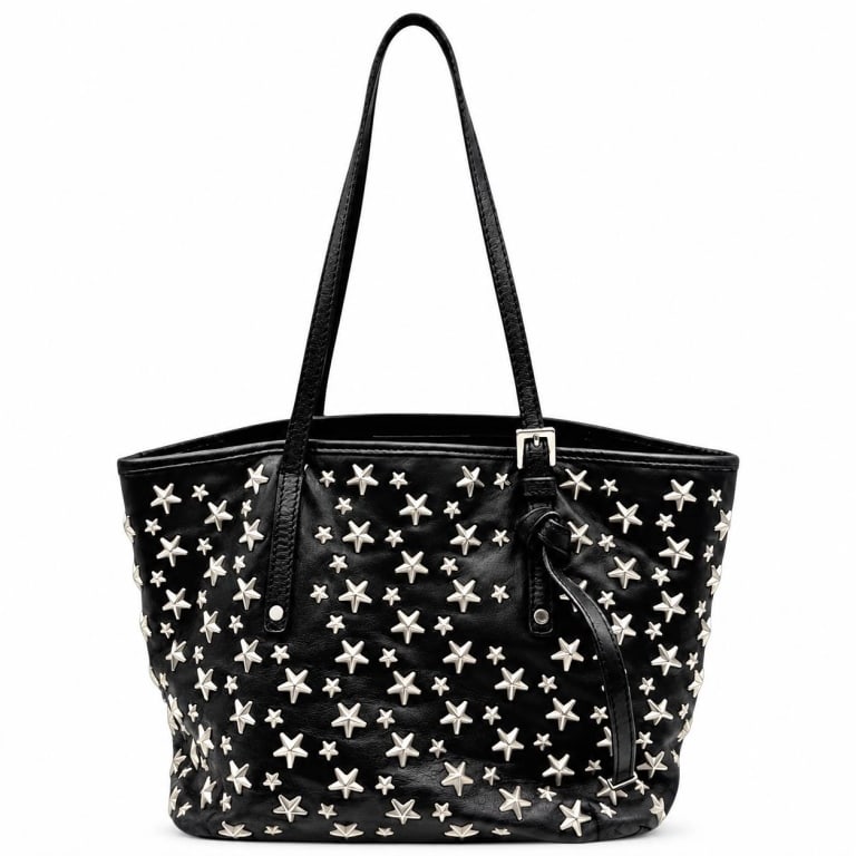 JIMMY CHOO SASHA STAR STUD LEATHER TOTE 15": Jimmy Choo Sasha M tote crafted in supple black leather and lavishly embellished with the house's signature silver-tone stars in graduated sizes. The softly structured, generously proportioned