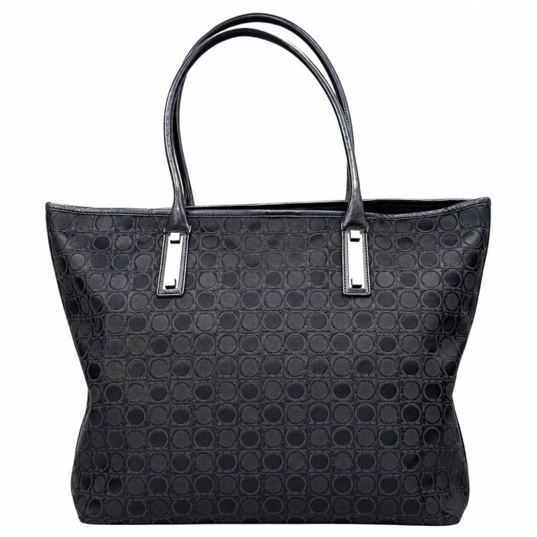 SALVATORE FERRAGAMO GANCINI BLACK TOTE 14": Salvatore Ferragamo black Gancini monogram tote crafted in woven jacquard fabric with an allover tonal Gancini pattern, black leather trim and long dual leather shoulder handles. Sleek silver-tone rec