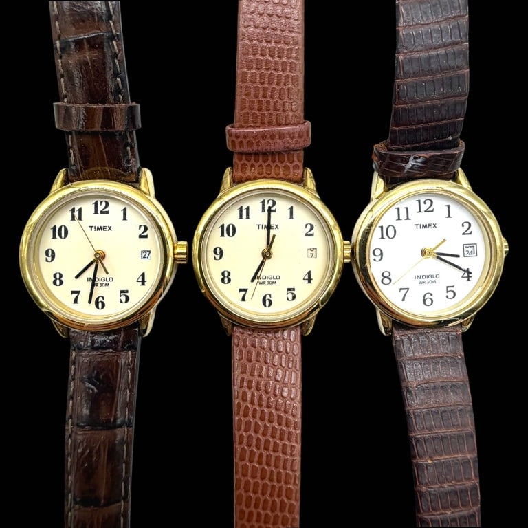 LOT OF 3 TIMEX INDIGLO WATCHES SMALL FACE 20MM: Lot of three vintage-style Timex Indiglo wristwatches, each with an approximately 20 mm round case excluding crown. All feature white dials with black Arabic numerals, date windows at 3 o'clock, quart